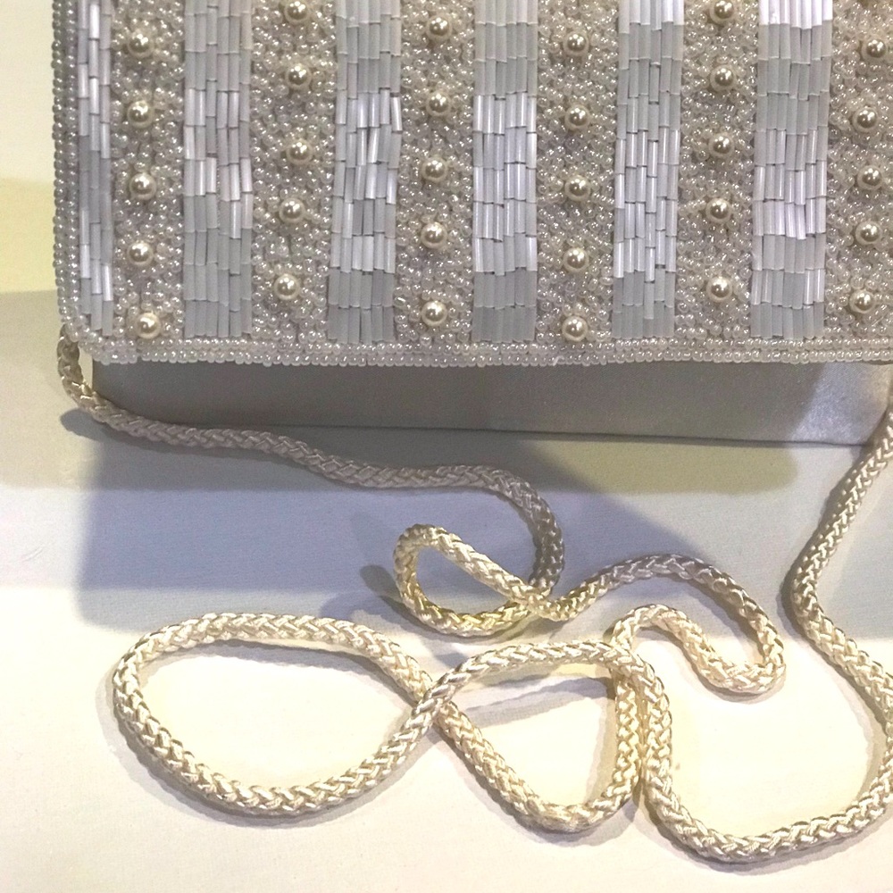 Off White beaded clutch with cord for shoulder strap